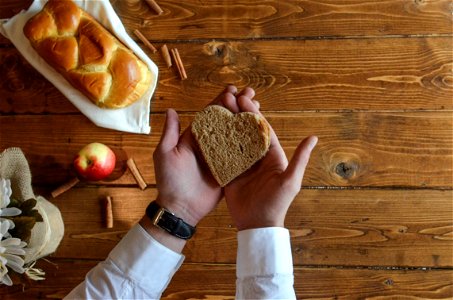 Person Holding Heart Shaped Bread photo