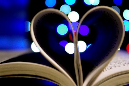 Photo Of Bookpages Folded Into Heart Shape With Bokeh Light Background photo