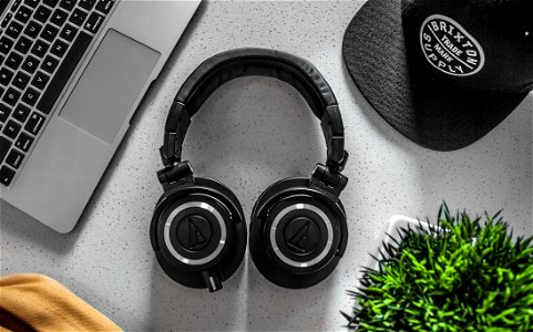 Black Wireless Headphones On White Table photo