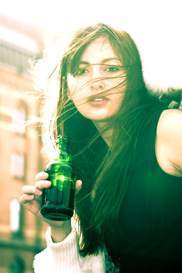 Woman In Black Sleeveless Shirt Holding A Bottle