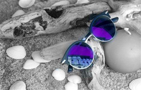 Neo Chrome Sunglasses With Silver And Black Frame On Brown Firewood photo