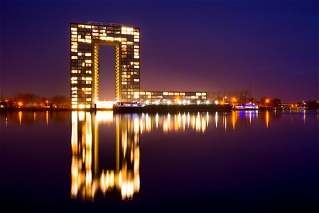 City Building Near Body Of Water During Nighttime photo