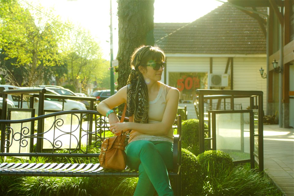 Woman In Brown Tank Top Sitting On Black Bench Beside Tree