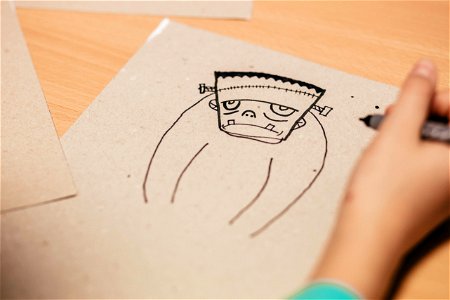 Kid Draws Cartoon Character Figure photo
