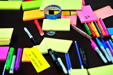 Photo Of Sticky Notes And Colored Pens Scrambled On Table photo