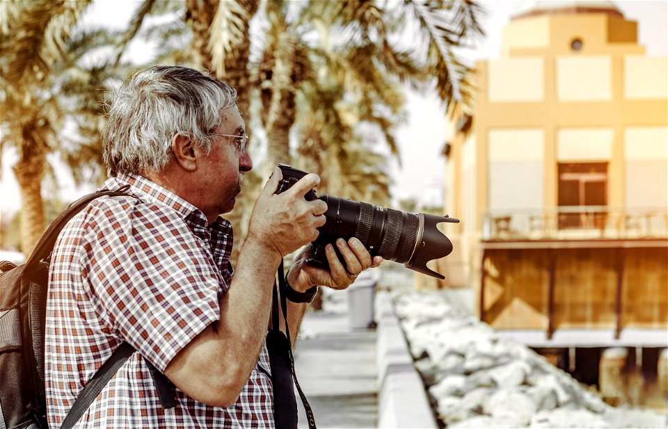 Man Holding Dslr Camera photo