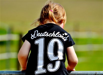 Girl Wearing Deutschland 19 Black T Shirt During Daytime photo
