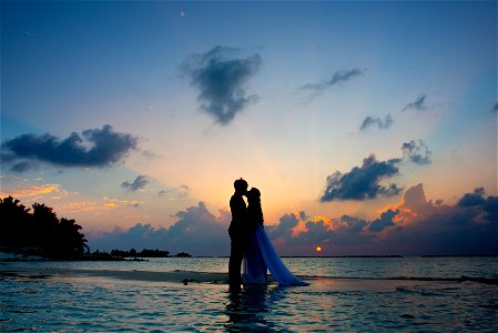 Silhouette Photo Of Man And Woman Kisses Between Body Of Water photo
