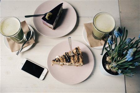 Photo Of Sliced Cakes And Milk Tea Near Plant photo