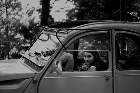 Grayscale Photo Of Woman Inside Classic Car