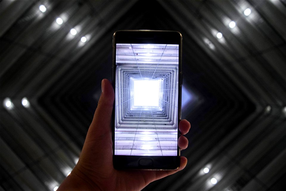 Person Holding Black Smartphone With Illustration Photo