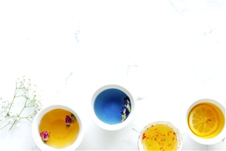 Four Ceramic Teacups Filled With Teas