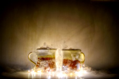 Two Red And Gold Mugs And Yellow String Lights photo