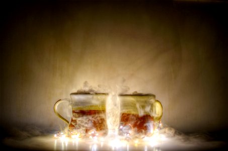 Two Red And Gold Mugs And Yellow String Lights