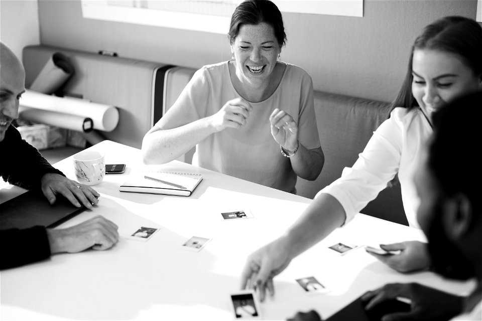 Grayscale Photography Of Four Person Having A Discussion photo