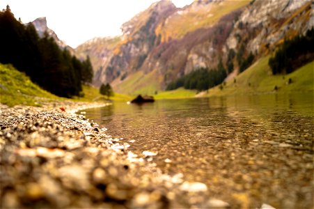 Shallow Focus Photography Of Body Of Water Near Mountain photo