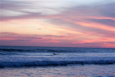 Panoramic Photography Of Surfing Man At Sunset photo
