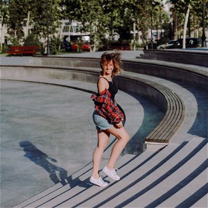 Photo Of Woman In Black Tank Top Walking On Stairs At A Park photo