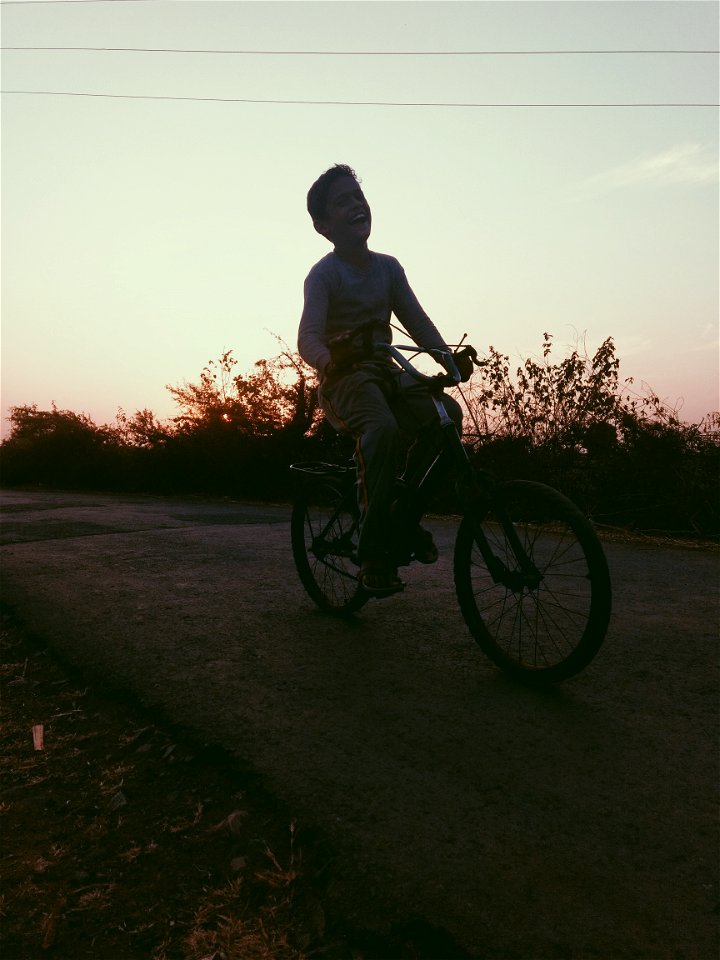 Boy Riding Of Bicycle photo