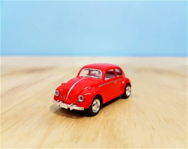 Depth Of Field Photography Of Red Volkswagen Beetle Diecast Model photo