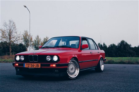 Photography Of Red BMW On Asphalt Road photo