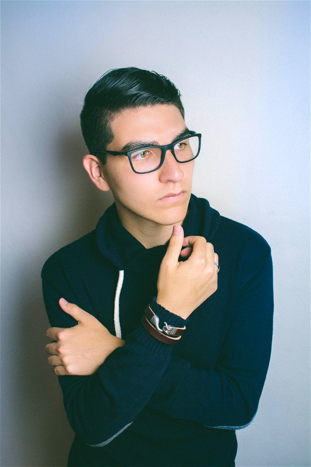 Man Wearing Eyeglasses Standing Near The Wall photo