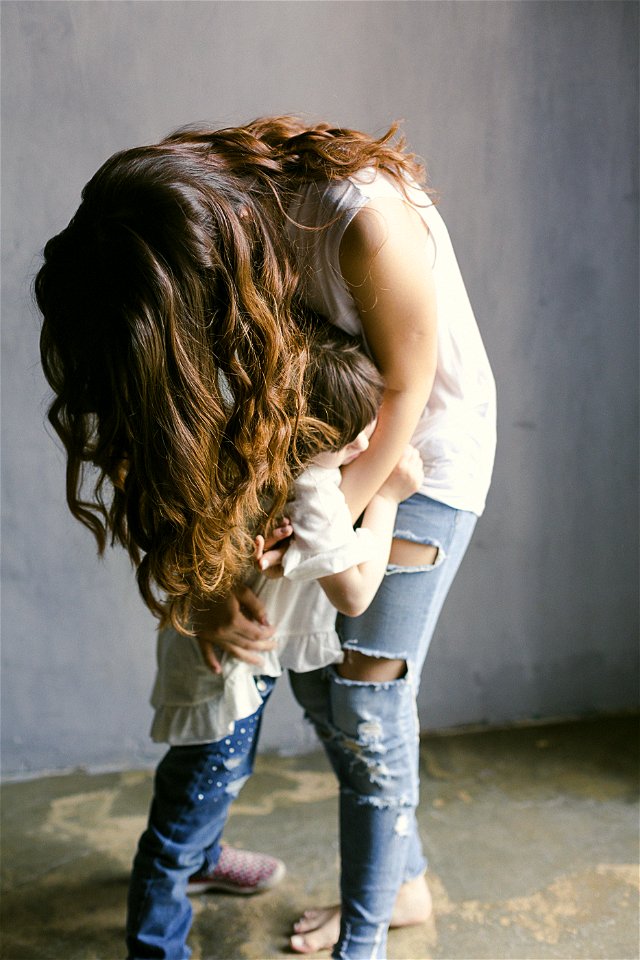 Mother Hugging Her Daughter photo