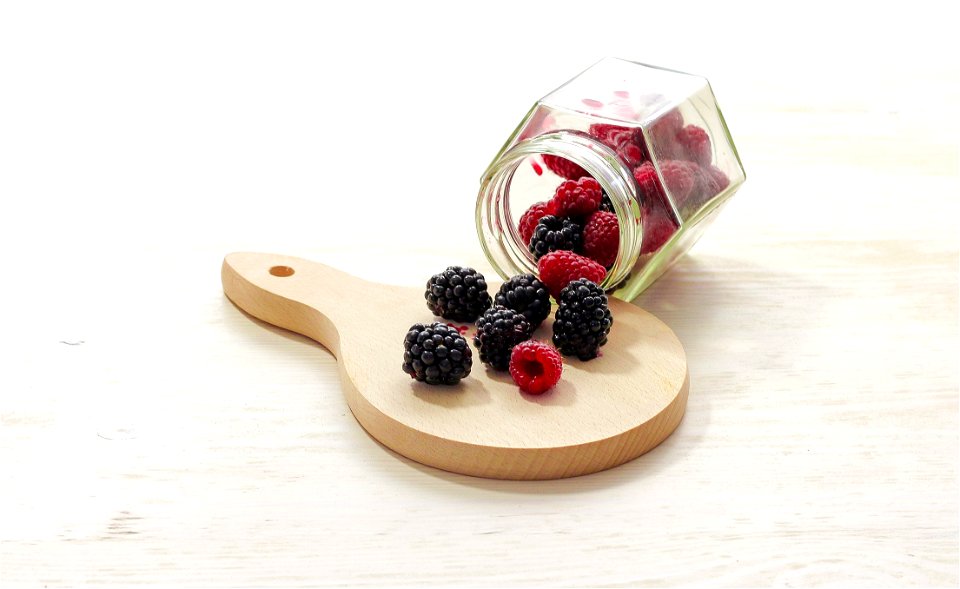 Clear Glass Bottle With Raspberries Inside photo