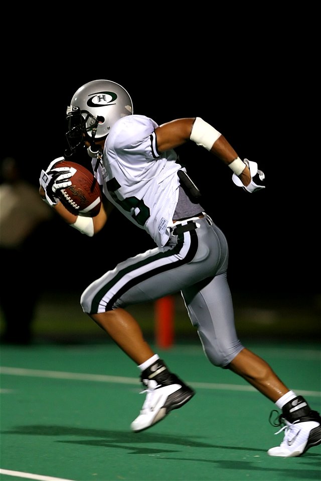 Football Player Holding Football