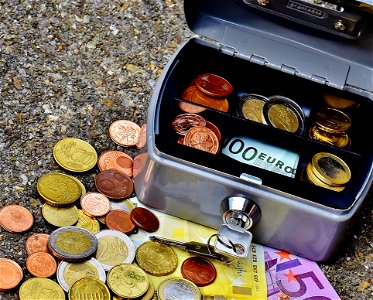Coins And Banknotes In Metal Box photo