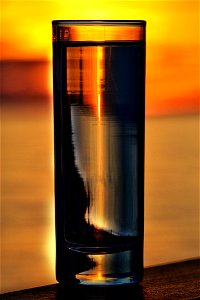 Glass Of Water Illuminated By A Sunset photo