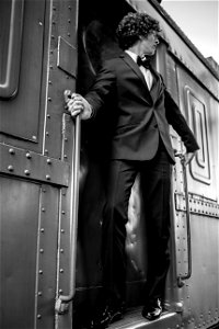 Man On Doorway Of Train photo