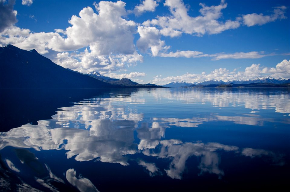 Lake Water Under White And Blue Skies During Daytime photo