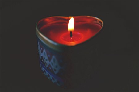 Close-up Of Tea Light Candle Against Black Background photo