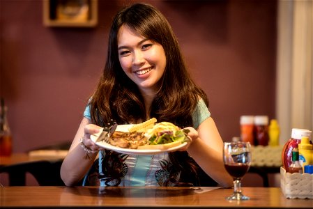 Smiling Girl Shows Her Plate Of Food photo
