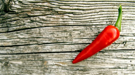 Chili Pepper On Wooden Background photo