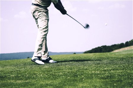 Man In White Denim Pants And Black Sandals Playing Golf During Daytime