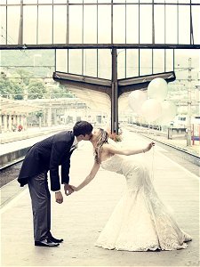 Couple Kissing Standing On The Train Waiting Platform photo