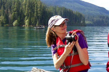 Young Woman with Camera in Boat, Mt Baker Snoqualmie National Forest