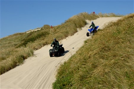 Pair of Field Rangers descending Sand Dune at Oregon Dunes, Siuslaw National Forest photo