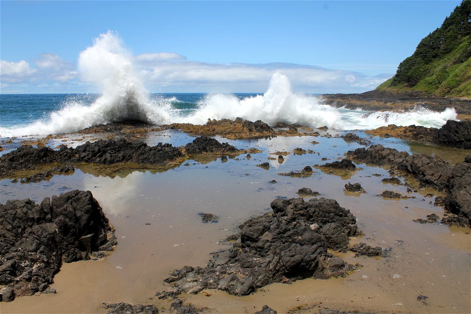 Tidepool and crashing waves at Cape Perpetua on the Siuslaw National Forest photo