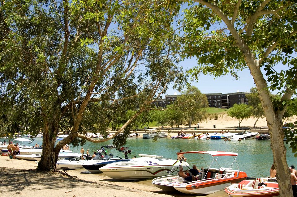 Boaters crowd the beach and enjoy the water near the London Bridge on Lake Havasu