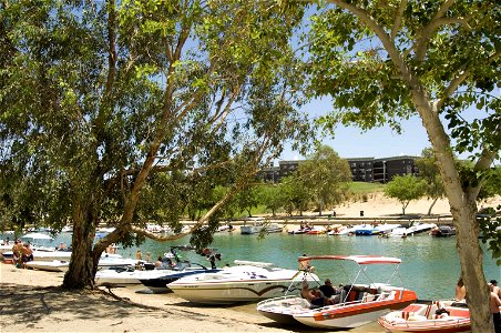 Boaters crowd the beach and enjoy the water near the London Bridge on Lake Havasu