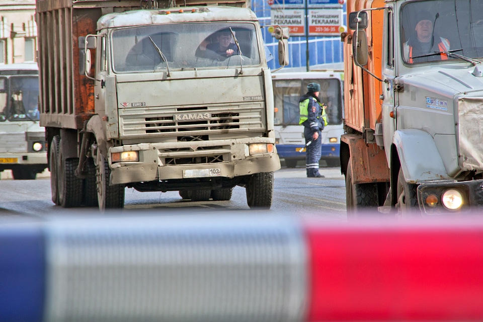 Officer between trucks