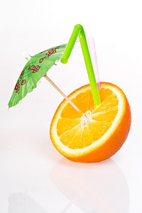 Orange with drinking straw photo
