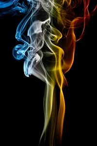 Multi colored smoke on black photo