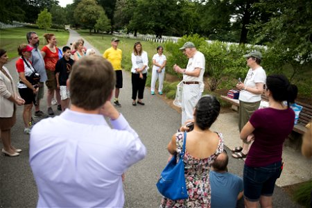 Paul Wackerbarth, volunteer with Monarch Teacher Network, gives remarks to nearly 30 attendees of a butterfly release in Arlington National Cemetery, Aug. 9, 2016, in Arlington, Va. The cemetery plant photo