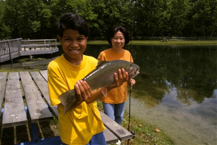Image title: Son showing trout fish he caught mother stads proudly behind at lake Image from Public domain images website, http://www.public-domain-image.com/full-image/sport-public-domain-images-pict photo