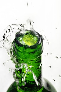 Splashing water from green bottle