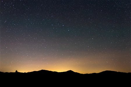 Starry Night Sky and Mountain Silhouettes photo